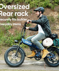 Man riding Folding Fat Tire Electric Bike for Adults With 1500W Peak Motor, 60 to 80 Mile Range, 48V 13Ah Battery, Klein Blue, on path
