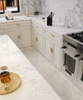 Modern kitchen with marble countertops and cabinets featuring 25 Pack Adjustable Cabinet Handles Gold Brass Drawer Pulls Center To Center Adjustable 1 To 4 Inches 25 To 102 mm Overall Length 4.41 Inches Top Notch Durable Brass Kitchen Cabinet Hardware For Cabinets And Drawers.