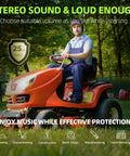Man mowing grass wearing Bluetooth 5.4 Hearing Protection Headphones With AM FM Radio, 25dB NRR Earmuffs, on orange tractor.