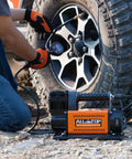 Heavy Duty 12V Portable Air Compressor With Digital Pressure Gauge Tire Inflator Kit inflating a tire outdoors.