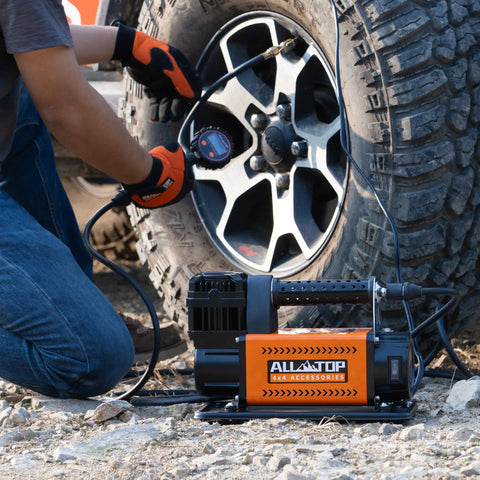 Heavy Duty 12V Portable Air Compressor With Digital Pressure Gauge Tire Inflator Kit inflating a tire outdoors.