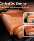 Upgrade Your Mini John Cooper Works Electric With This Cool Leg Support Cushion Made For 2025 And 2026 Models To Boost Legroom Big Time and Keep You Chill On Long Drives Without Worrying About Cramped Knees. Close-up of leg support cushion in orange leather showing installation difference before and after.