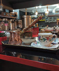 Top Notch Solid Copper Cezve For Turkish Greek Arabic Coffee With Engraved Finish And Wooden Handle 6 Oz Stovetop Pot displayed on countertop