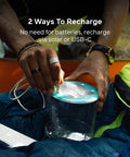 Person charging Luci Original Solar Inflatable Camping Lantern With USB C Recharge using USB-C cable outdoors
