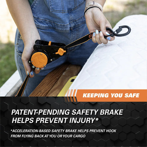 User demonstrating Heavy Duty Retractable Ratchet Tie Down Straps One Inch By Ten Feet Five Hundred Pound with safety brake.