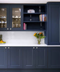 Brushed Nickel Cabinet Pulls 1-1/4 Inch Modern Disc Knobs for Kitchen Cabinets and Dressers on navy blue cabinetry.