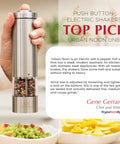 Battery Operated Salt And Pepper Grinder Set With Light Stainless Steel Mills Two Piece Auto One Handed Operation Electronic Adjustable Shakers Ceramic Grinders Rustproof Core For Smooth Grinds And Sleek Kitchen Style in hand next to guacamole