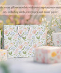 Two Large 13 Inch Floral Gift Bags With Matching Tissue Paper Card And Envelope Set Hand Painted Bloom Design Totally Perfect For Any Occasion Great For Women Gifts And Special Occasions on display with floral background.