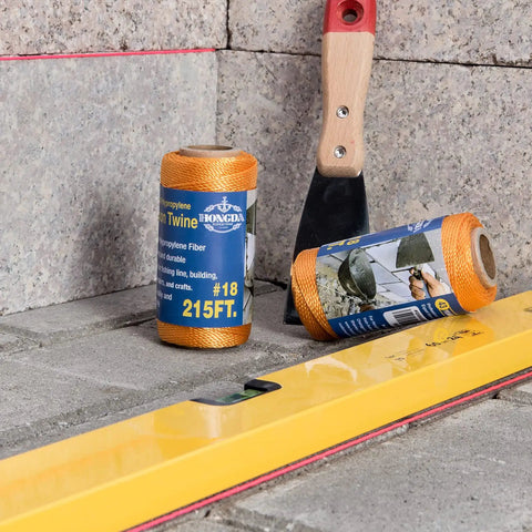 Yellow level and orange polypropylene twine on pavement, not the Fluorescent Pink Twisted Mason Line 425 Feet Size 18 Polypropylene Mason Line String for Masonry Jobs, General Construction Layout, Gardening, and DIY Projects Pack of 6