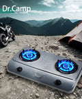 35000 BTU Two Burner Propane Gas Stove Cooktop for Outdoor Camping with glowing blue flames beside tent and motorcycle
