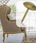 Rock Solid Brass Upholstery Tack Strips 10 Pack 32 Foot Decorative Nail Bands For Couch And Chair Reupholstering shown on a styled chair.