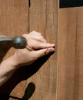 Top Shelf 2.5 Inch 304 Stainless Steel Wood Siding Nails With Annular Ring Shank and Sharp Diamond Point being hammered into wood.