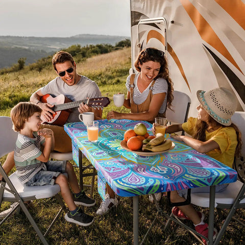 Family enjoying picnic with waterproof picnic table cover with bench covers for 6 foot rectangular tables, backdrop of an RV.