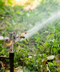 Heavy Duty Brass Impact Sprinkler Heads With Adjustable 360 Degree Coverage For Lawns And Gardens 9 Pack spraying water over grass.