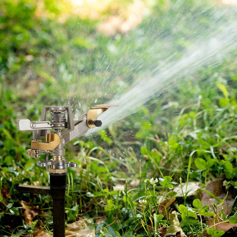 Heavy Duty Brass Impact Sprinkler Heads With Adjustable 360 Degree Coverage For Lawns And Gardens 9 Pack spraying water over grass.