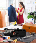 Grab-and-Go Handheld Sewing Machine Kit With 142 Piece Essentials, Wooden Storage Box, Dual Power Supply, Electric Switch, Heavy-Duty Scissors, Assorted Needles And Threads For Quick Home Repairs, with wooden box and tools on worktable