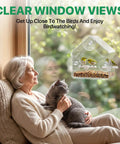 Elderly woman with a cat enjoying birds at a Clear Window Bird Feeder With Strong Suction Cups Acrylic Window Feeder for Year-Round Bird Watching.
