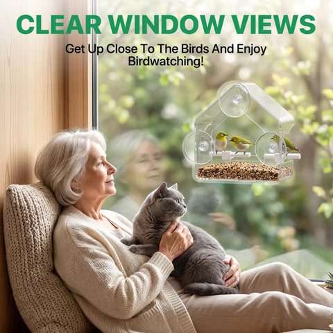 Elderly woman with a cat enjoying birds at a Clear Window Bird Feeder With Strong Suction Cups Acrylic Window Feeder for Year-Round Bird Watching.