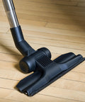 Universal 30 Ft Central Vacuum Kit With Suction Driven Turbo Nozzles For Versatile Cleaning On Hard Floors, close-up on hardwood floor.