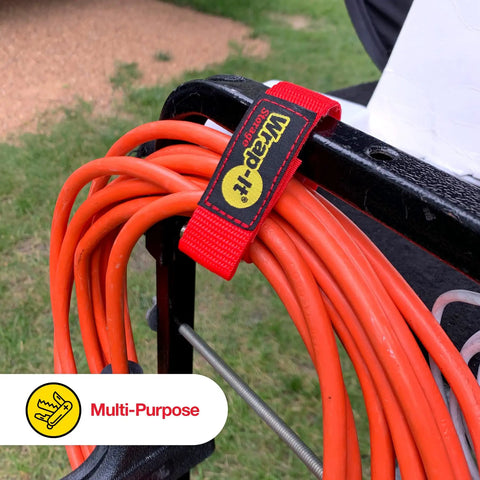 9 Inch Red Quick-Strap Cord Wraps, securing orange extension cords on black holder, outdoor setting