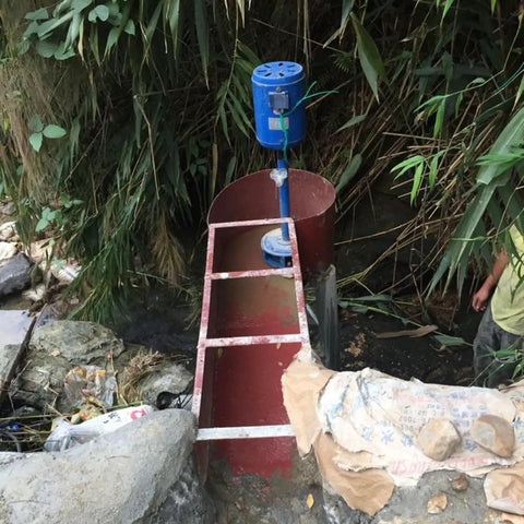 Installed Three Phase Axial Flow Hydroelectric Generator For Low Head Water Turbines, 3000W And 5000W Models, in a creek setting.