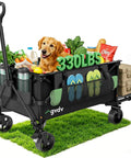 Foldable Wagon Cart With Tailgate And 42 Inch Extended Handle loaded with groceries, a dog, and 330 lbs capacity sign on grass
