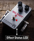 Close-up of Ram's Head Big Muff Pi Fuzz Pedal With True Bypass And Battery Included, Vintage Look And Graphics, LED indicator on.