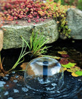 Grade A 132 GPH Solar Fountain Pump And Panel Kit Built With Dependable Battery Pack And Bright Led Light Lifts Water A Clean 56 Inches High For Zero Stress Setup And Backyard Glow Ups in a pond with bubbles and plants.