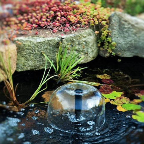 Grade A 132 GPH Solar Fountain Pump And Panel Kit Built With Dependable Battery Pack And Bright Led Light Lifts Water A Clean 56 Inches High For Zero Stress Setup And Backyard Glow Ups in a pond with bubbles and plants.