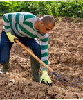 Man using Handheld Manure Fork All Purpose Iron Tool For Farm And Lawn Cleanup Tough Raking For Horse And Cow Manure Grass