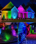 Two Pack Outdoor RGBW LED Spotlight Kit With Remote Control illuminating house and garden in vibrant colors at night.