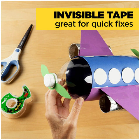 Three Roll Dispenser Pack Invisible Clear Tape For Quick Repairs on a craft rocket model and scissors on a table