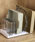 StoreMore Adjustable Bakeware Rack with steel wires, organizing cookie sheets, pans, and trays in kitchen cabinet, seven dividers visible.