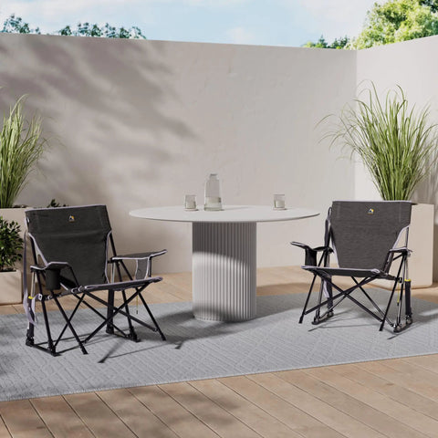 Two Kickback Rocker Outdoor Low Profile Rocking Chairs With Cup Holder And Portable Carry Strap on a patio with a table.