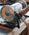 BG-GRIND4 4-piece grinding jig set installed on a bench grinder; wood chisel being sharpened.