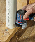 Person using GWS12V-30N 12V Max Brushless 3 Inch Angle Grinder Bare Tool For Tight Spaces And Quick Cuts 19,500 No Load RPM on PVC pipe