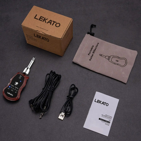Silent Practice Headphone Amp for Electric Guitar and Bass with Rechargeable Battery and accessories laid out on a surface