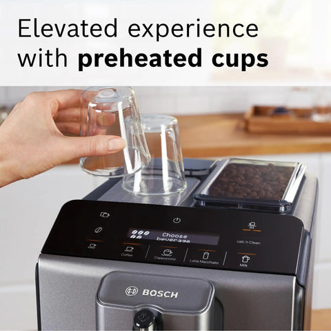 Fully Automatic Espresso Machine With Milk Frother System And Touch Control Panel Plus Cup Warmer For One Touch Latte And Cappuccino Maker In Sleek Dark Silver, showcasing preheated cups and touchscreen interface.