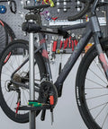 Heavy Duty Bike Repair Stand Go-To Tool For Home Mechanics holding a mountain bike in a garage setup