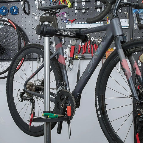 Heavy Duty Bike Repair Stand Go-To Tool For Home Mechanics holding a mountain bike in a garage setup