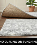 20 Pack Rug Grippers Non Slip Tape For Area Rugs On Hardwood Or Tile Floors Reusable Washable Double Sided Rug Pads Anti Curling Adhesive Stickers To Keep Rugs In Place And Prevent Slips Easy Install on a hardwood floor with a plant in the background.