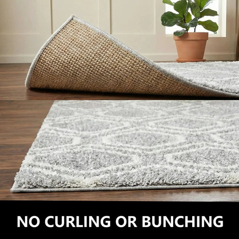 20 Pack Rug Grippers Non Slip Tape For Area Rugs On Hardwood Or Tile Floors Reusable Washable Double Sided Rug Pads Anti Curling Adhesive Stickers To Keep Rugs In Place And Prevent Slips Easy Install on a hardwood floor with a plant in the background.