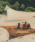 Family enjoying beach under Grande Portable Beach Tent Sun Shelter With 81 Sq Ft Shade 7 Ft Tall 9 By 9 Foot Canopy