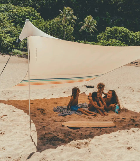 Family enjoying beach under Grande Portable Beach Tent Sun Shelter With 81 Sq Ft Shade 7 Ft Tall 9 By 9 Foot Canopy