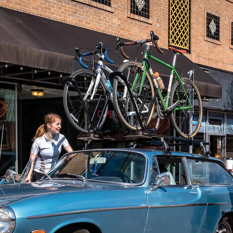 Rooftop Upright Bike Mount Carrier For Wheelbases Up To 52 Inches Easy No Fuss Transport With Wheel Only Clamps on blue car.