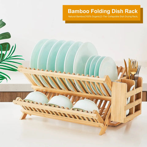 Heavy Duty Bamboo Dish Drying Rack Three Tier Collapsible Wooden Drainer With Utensil Holder holding plates and bowls on a kitchen counter.