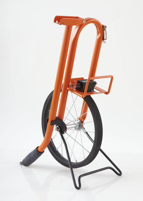 Measuring Wheel With Spoked Wheel And Metal Frame, Geared Mechanical Clicker Counter, Center Line Design, Feet Graduations, 11.5 Inch Diameter, Built Tough Three Quarter Inch Steel Frame, Dirt Shield Shelf, Bright Orange standing on stand.