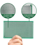 Person holding 10 Pack Double Sided FR4 PCB Boards 9x15 Cm Solderable Prototyping Boards For DIY Electronics with detail on holes and text.