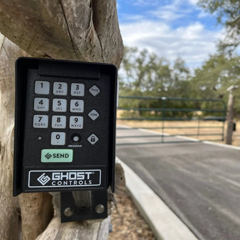 Premium Wireless Keypad For Automatic Gate Openers AXWK Model mounted on a wooden post, road in background