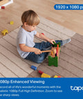 Child playing on a carpeted floor with toys, captured by 1080P Indoor Pan Tilt Security Camera Plug And Play For Home Surveillance C201.